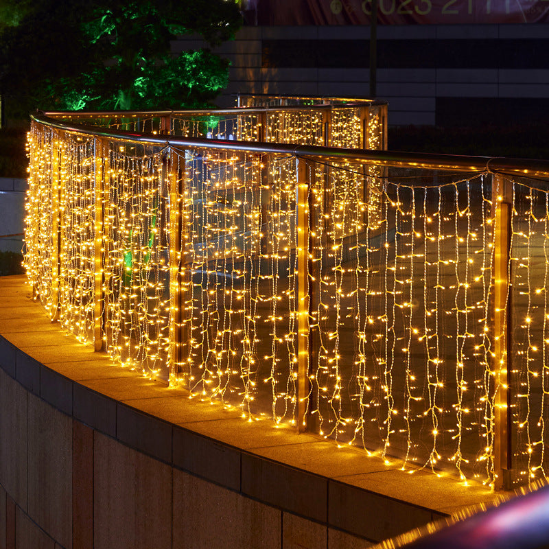 Decorative string lights on a railing at night