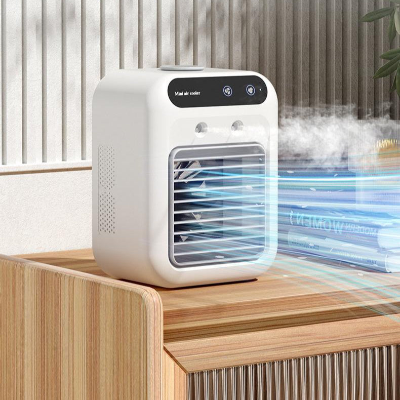 Portable air cooler emitting mist on a wooden surface with a blurred background